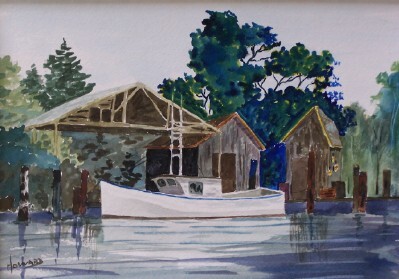 A boat docked in the water at a shack